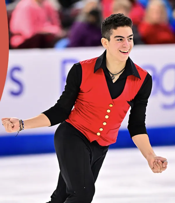 Ice skater Jacob Sanchez in black shirt and pants with red vest skating in performance